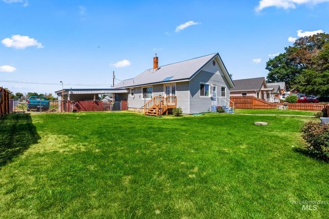 Back of property featuring a metal roof and a chimney | Image 4