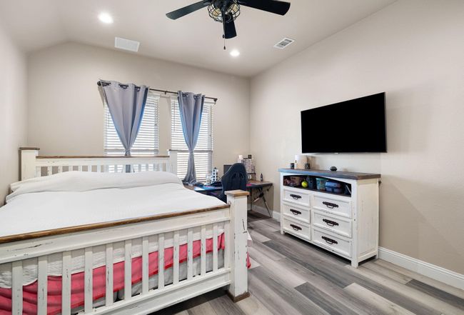 Bedroom featuring visible vents, light wood-style floors, and baseboards | Image 17