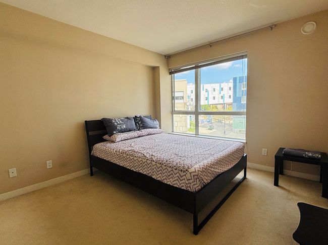 Bedroom with light carpet and baseboards | Image 7