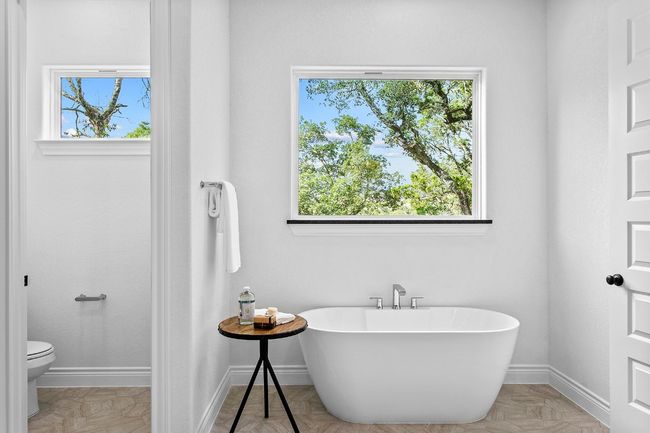 Bathroom featuring a soaking tub and healthy amount of natural light | Image 14