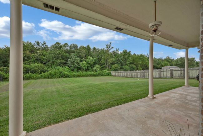 View of yard with a patio area and view of scattered trees | Image 29