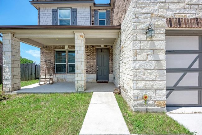 Property entrance featuring brick siding, a porch, and stone siding | Image 7