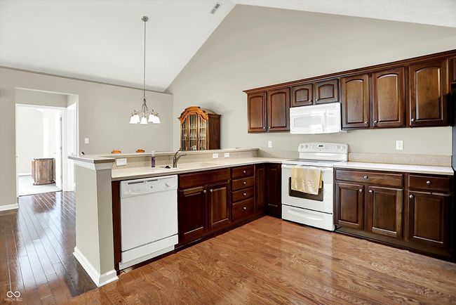 Kitchen featuring Corian Counter Tops and Wood Finish Flooring. | Image 11
