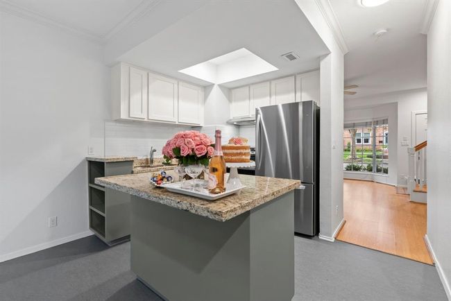 Granite counter tops and center island. NEW stainless steel refrigerator and stove. | Image 8