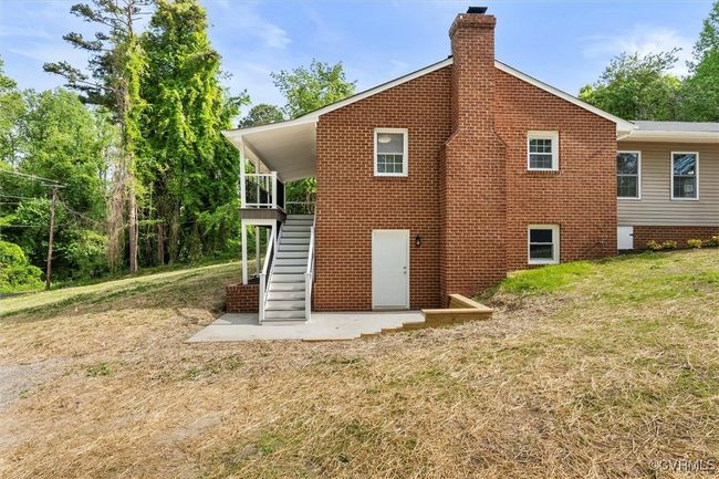 Back of house with a chimney, a yard, and stairs | Image 34