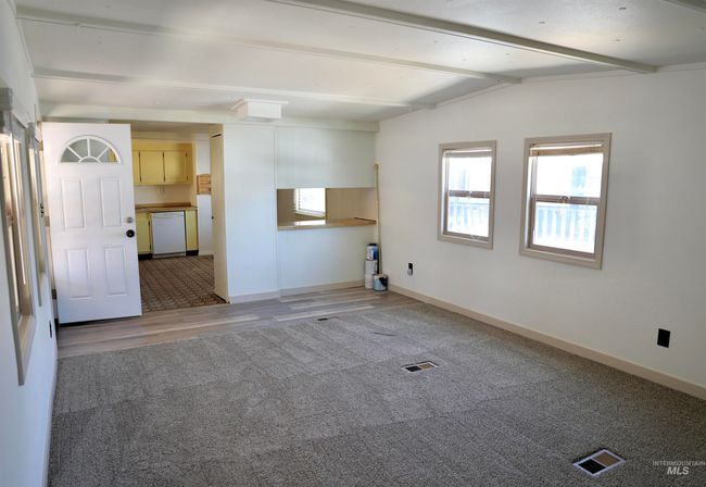 Empty room featuring light colored carpet and light wood-style floors | Image 4