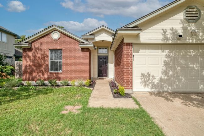 Single story home with brick siding, driveway, a front lawn, and a garage | Image 4