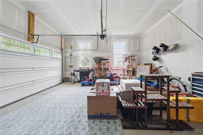 Attached two-car garage with storage and workspace potential. | Image 31