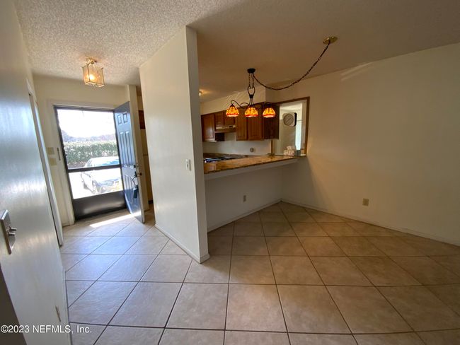 Entryway on the left side oh photo and breakfast counter on right side of photo | Image 10