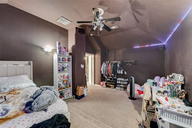 Carpeted bedroom featuring vaulted ceiling and ceiling fan | Image 21