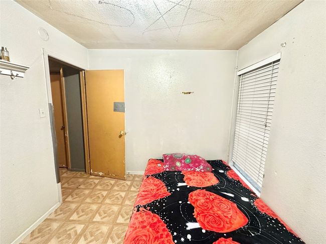 Unfurnished bedroom with baseboards, light flooring, and a textured ceiling | Image 28