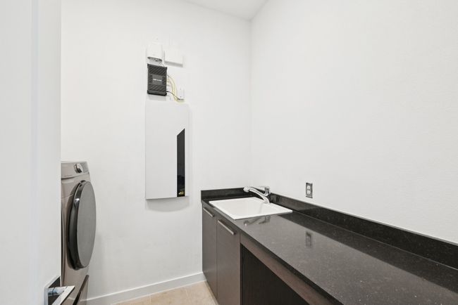 Washroom featuring washer / clothes dryer and light tile patterned flooring | Image 17