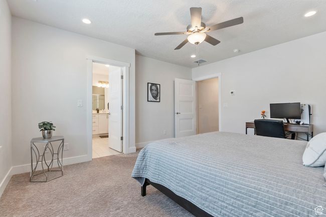 Bedroom with light carpet, recessed lighting, ceiling fan, and connected bathroom | Image 14