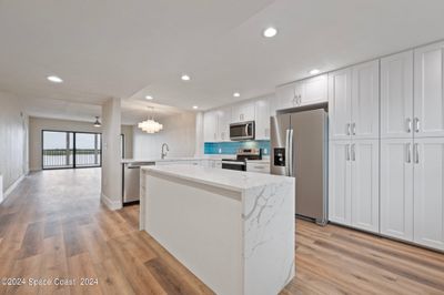 Quartz waterwall island in updated kitchen | Image 3