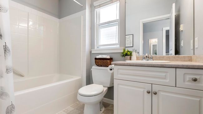 Bathroom featuring plenty of natural light, toilet, vanity, and shower / tub combination | Image 21