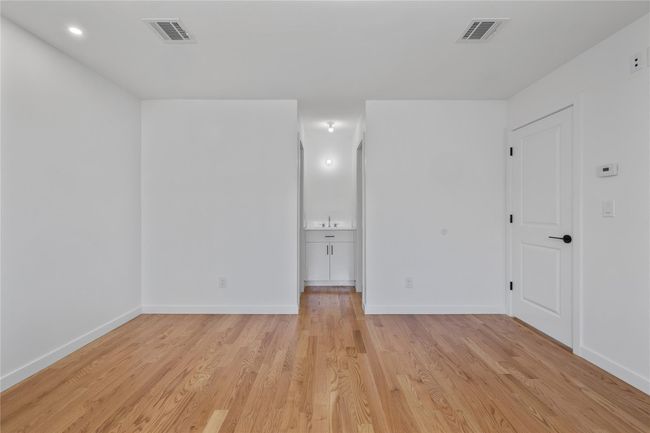 Empty room featuring baseboards, visible vents, and light wood-style flooring | Image 24