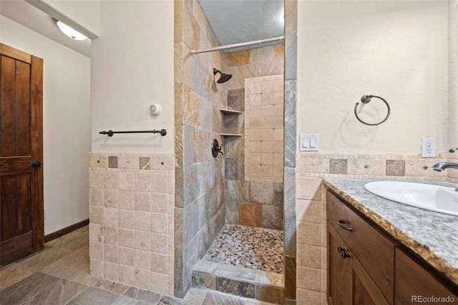 Stone Tile Shower, Pebbled Shower Floor, Alder Vanity with Granite | Image 24