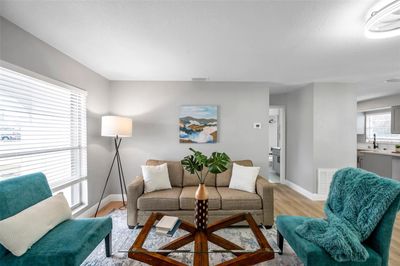 Bright and inviting living room with seamless views of the hallway leading to the guest bath and bedroom, plus easy access to the modern kitchen—designed for comfort and functionality! | Image 3