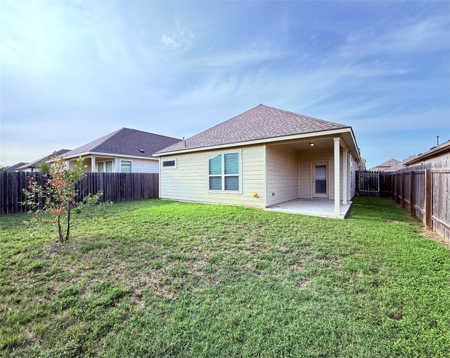 Rear view of house with a patio and roof with shingles | Image 17