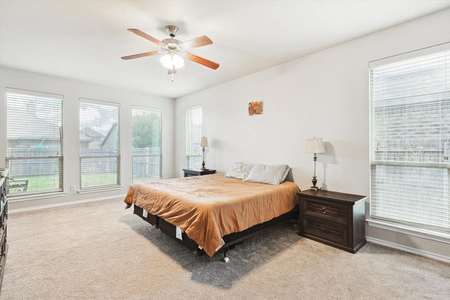 Bedroom with light carpet and ceiling fan | Image 15