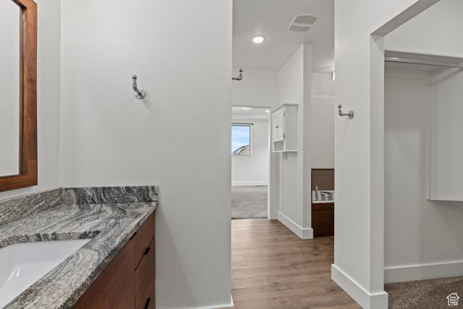 Bathroom featuring vanity, baseboards, and wood finished floors | Image 19