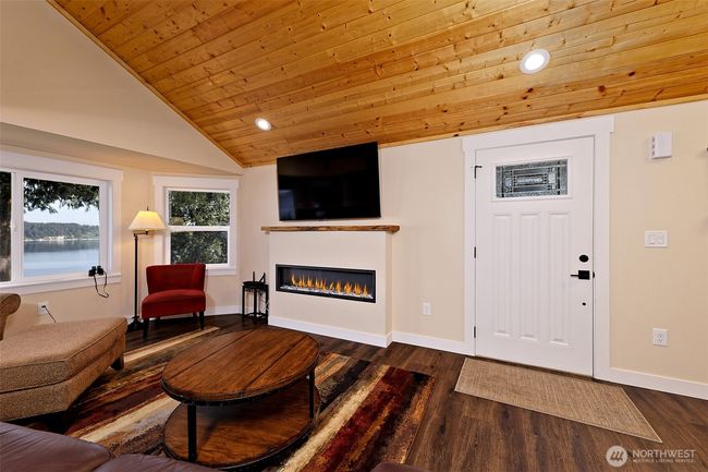 Entry to great room style layout with fireplace. | Image 12