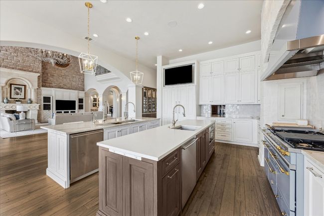 The gourmet kitchen is open to the spacious family room. | Image 13
