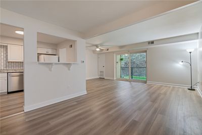 Step inside this fully updated unit that is move in ready with new flooring, new slider and windows and freshly painted throughout. | Image 3