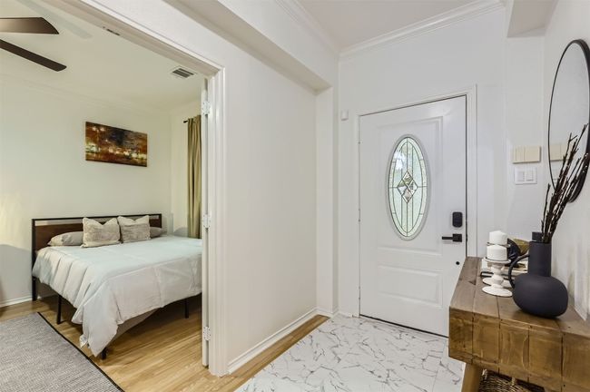 Foyer featuring crown molding, ceiling fan, and light marble finish flooring | Image 25