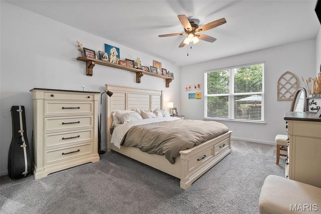 Bedroom featuring light carpet and ceiling fan | Image 14