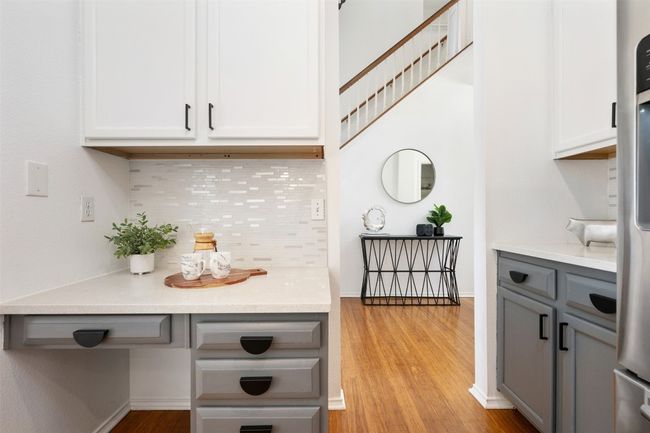 Bar with baseboards, freestanding refrigerator, decorative backsplash, and light wood finished floors | Image 14