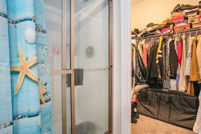 Bathroom featuring a shower stall and a walk in closet | Image 16