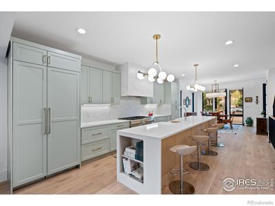 Spa-like open floorplan with light palette. Kitchen features a 12 waterfall island and Thermador appliances. | Image 3