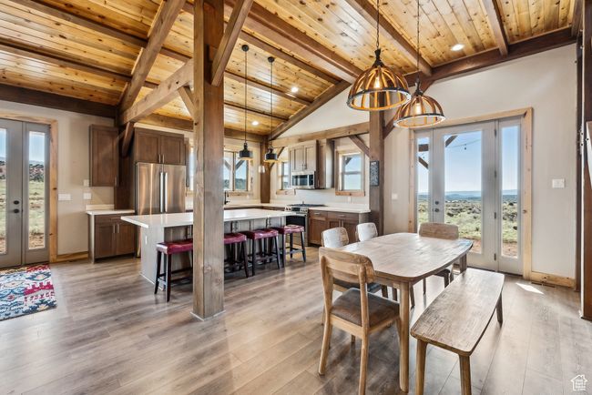 Dining area featuring french doors, lofted ceiling with beams, light wood-type flooring, and wooden ceiling | Image 7