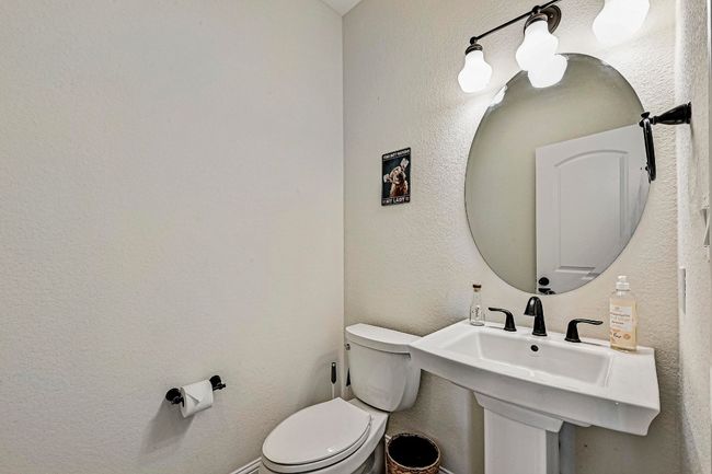 Half bathroom featuring toilet and a textured wall | Image 27
