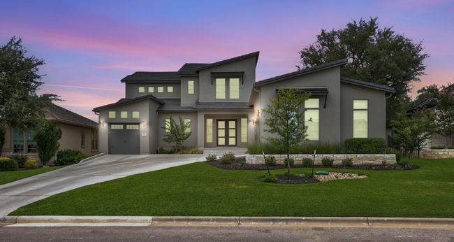 Contemporary home featuring driveway, stucco siding, a yard, and french doors | Image 32