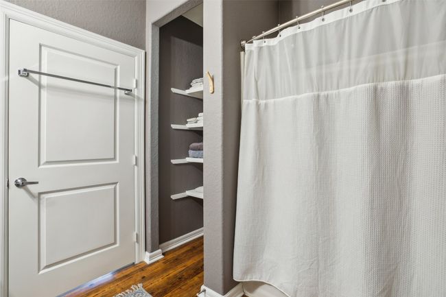 Bathroom 2 with wood plank laminate flooring and a shower with shower curtain | Image 21
