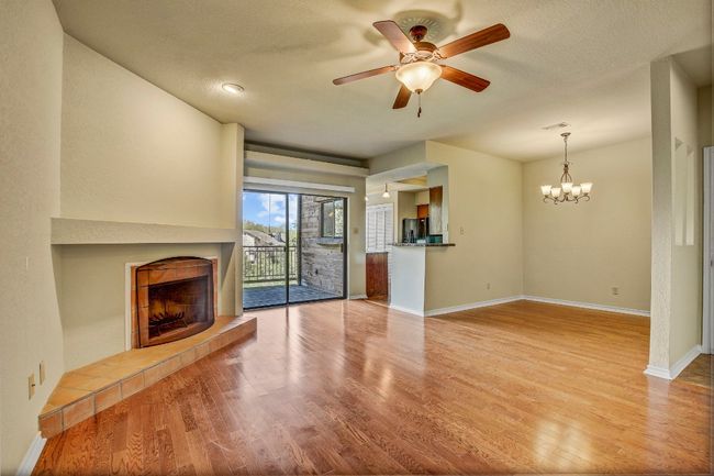 Living room with wood floors, a ceiling fan and a beautiful fireplace too | Image 6