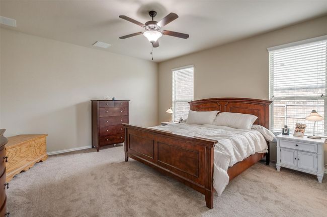 Oversized primary suite with ceiling fan, carpet and great windows. | Image 11
