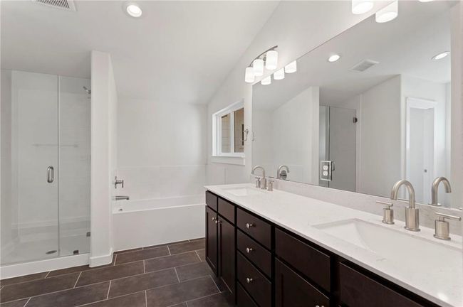 Bathroom featuring a shower stall, a garden tub, double vanity, tile patterned floors, and recessed lighting | Image 19