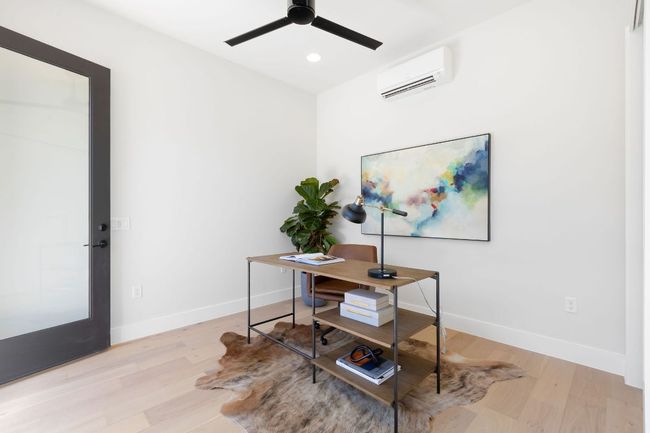 Office area with wood finished floors, baseboards, and a wall mounted AC | Image 34