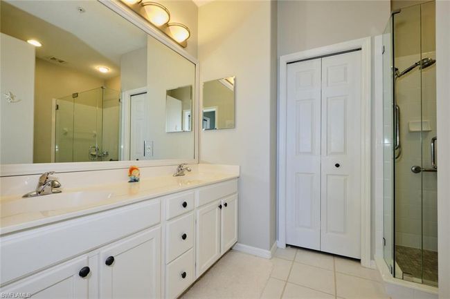 Bathroom featuring walk in shower, tile patterned floors, and vanity | Image 37