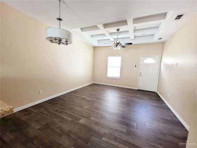 Foyer with a ceiling fan, coffered ceiling, a chandelier, beam ceiling, and dark wood-type flooring | Image 12
