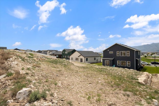 Back of property with a residential and a mountain view | Image 29