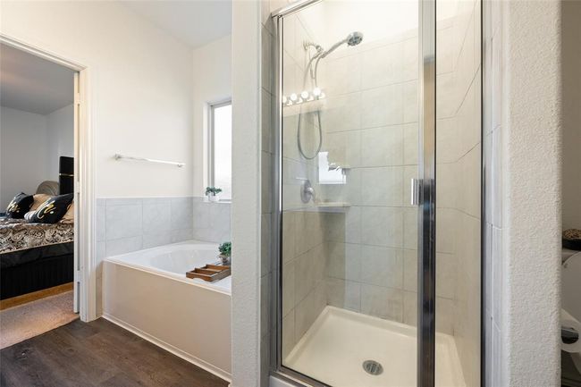 Ensuite bathroom with a bath, wood finished floors, and a shower stall | Image 18