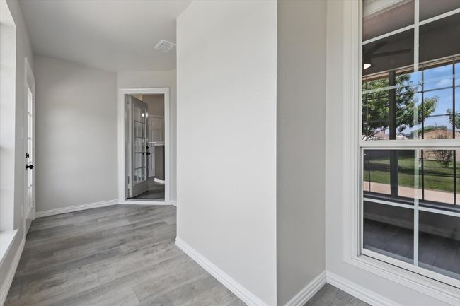 Hall featuring wood finished floors and baseboards | Image 17