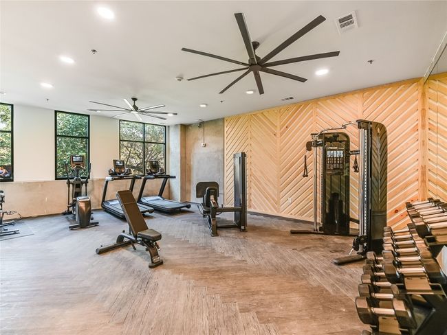 Gym featuring a ceiling fan, recessed lighting, and wood walls | Image 15