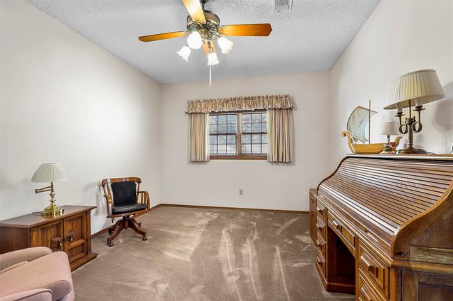 Living area featuring ceiling fan, carpet floors, and a textured ceiling | Image 22