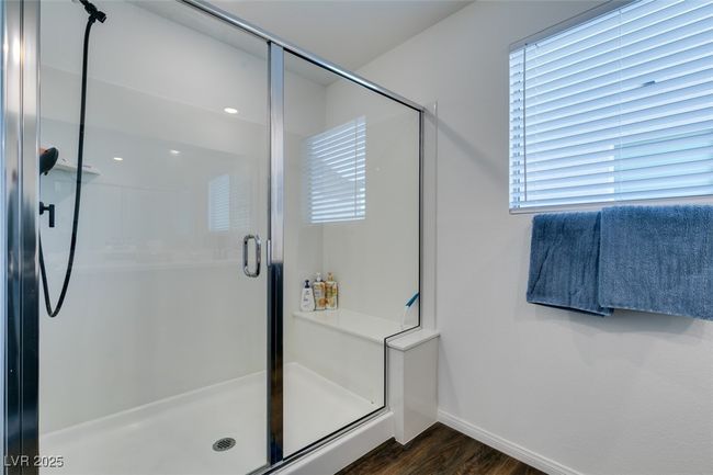 Bathroom with a stall shower, baseboards, and wood finished floors | Image 33