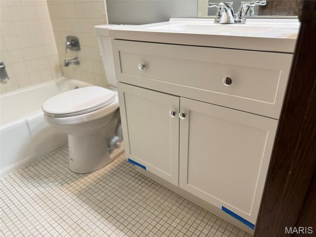Bathroom featuring vanity, washtub / shower combination, and tile patterned floors | Image 19
